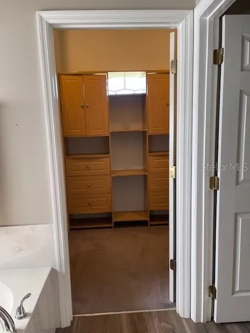 a kitchen with stainless steel appliances granite countertop a sink and a refrigerator