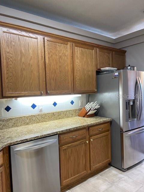 4493 Southwest 102nd Lane Road Ocala, FL 34476 - Photo 33 of 63 a kitchen with stainless steel appliances granite countertop a sink and a refrigerator