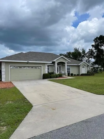 a front view of house with yard and garage