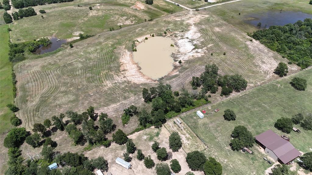 8605 West Highway 199 Springtown, TX 76082 - Photo 4 of 23 Expansive rural property featuring an earth-toned pond, a second smaller pond, and mature tree clusters