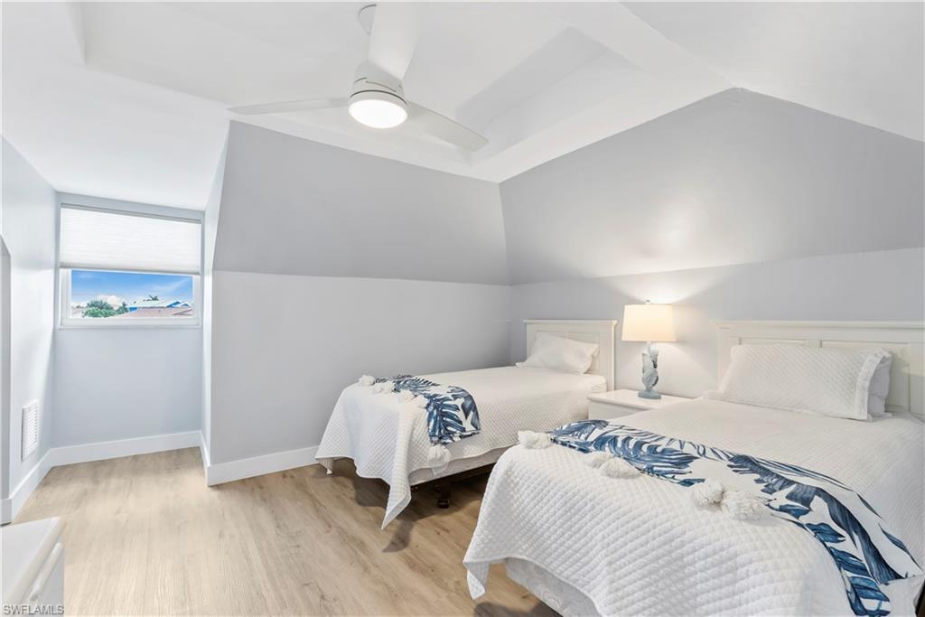 541 94th Avenue North Naples, FL 34108 - Photo 12 of 21 a bedroom with two beds and a lamp