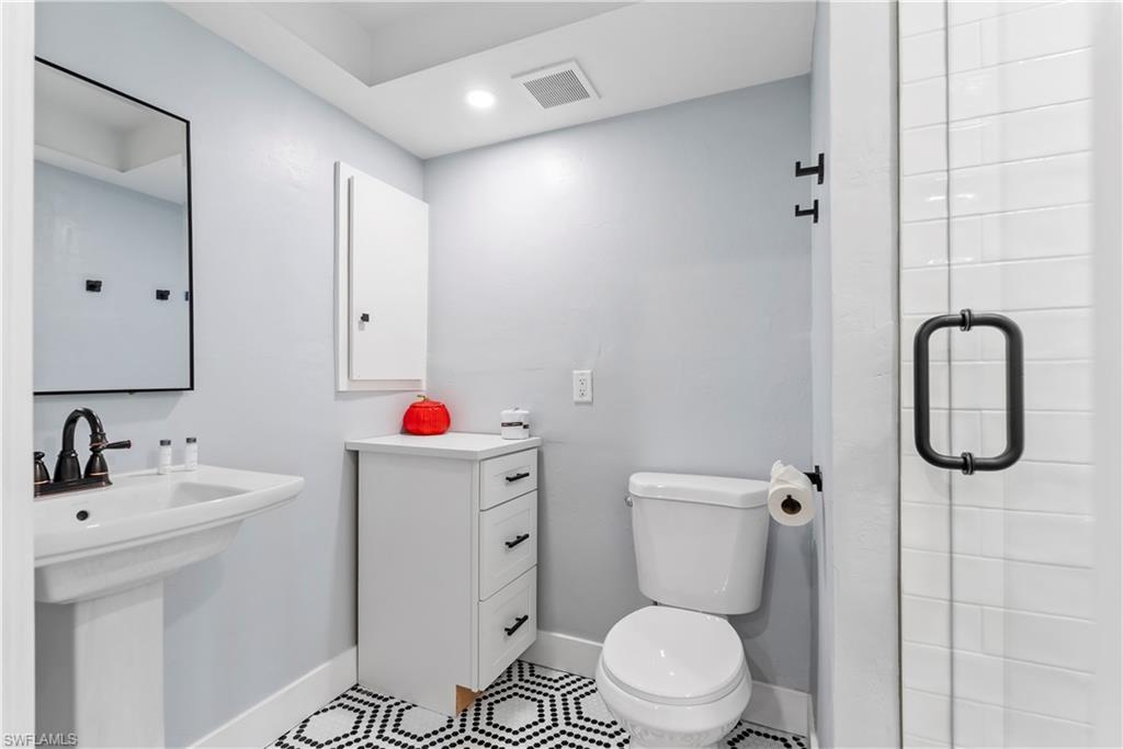 541 94th Avenue North Naples, FL 34108 - Photo 13 of 21 a bathroom with a sink toilet and a mirror