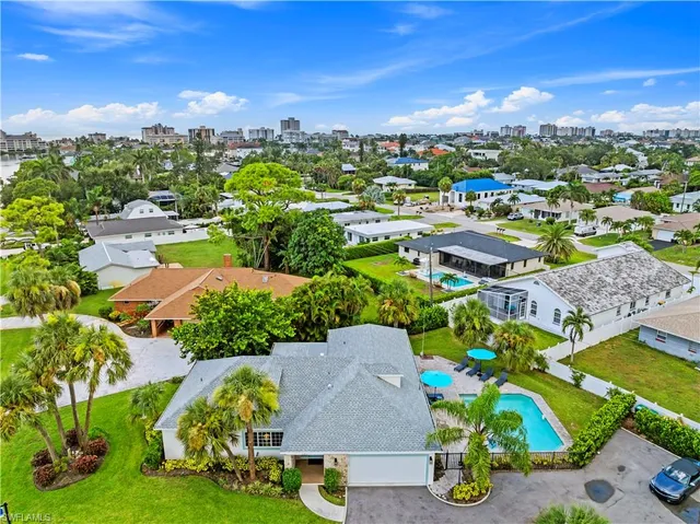 an aerial view of residential houses with outdoor space and street view