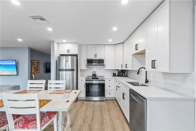a kitchen with a sink stove and refrigerator