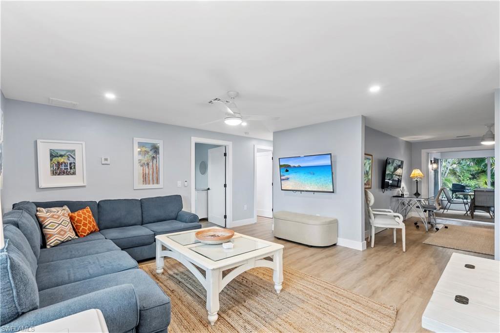 541 94th Avenue North Naples, FL 34108 - Photo 6 of 21 a living room with furniture and a wooden floor