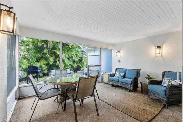 a view of a livingroom with furniture and floor to ceiling window