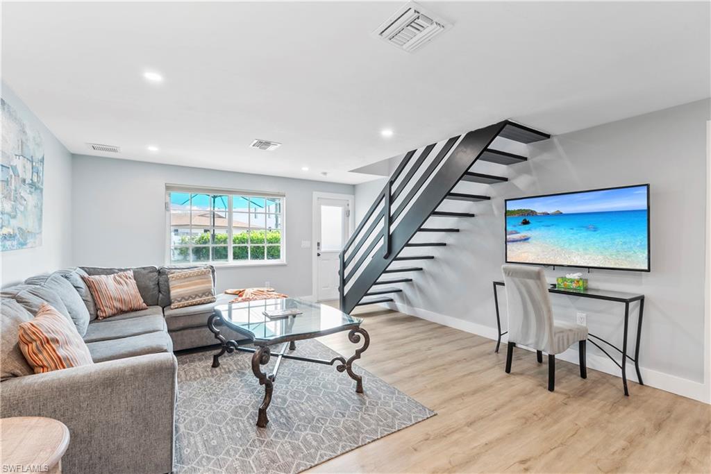 541 94th Avenue North Naples, FL 34108 - Photo 10 of 21 a living room with furniture and a wooden floor
