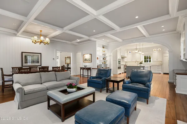 a living room with furniture and a view of kitchen