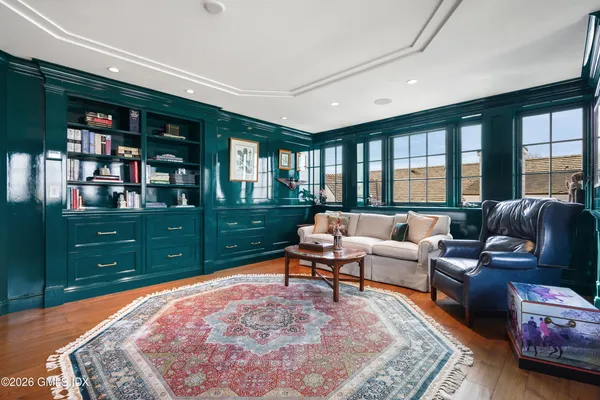 a living room with furniture and a floor to ceiling window