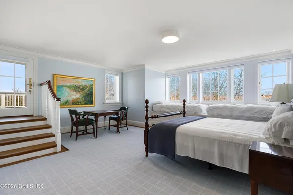 a bedroom with two beds and a couch