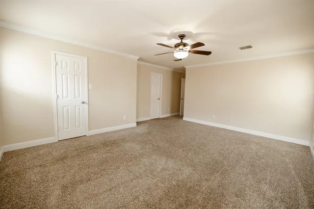 a view of an empty room with a fan
