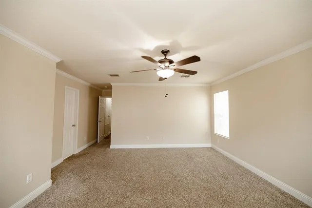a view of a livingroom with a ceiling fan and window