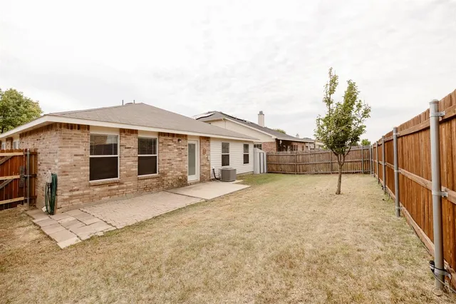 a view of a house with wooden fence
