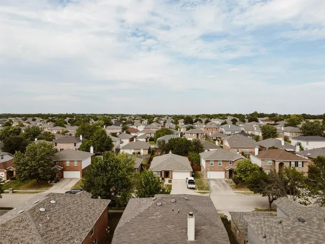 an aerial view of a house with a yard
