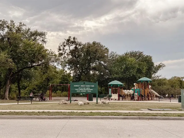 a view of a park with swings and slides