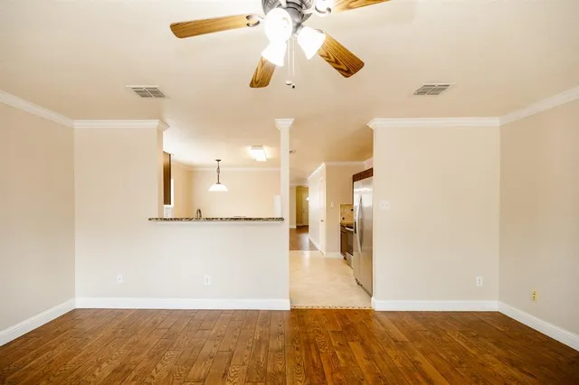 a view of a kitchen with wooden floor