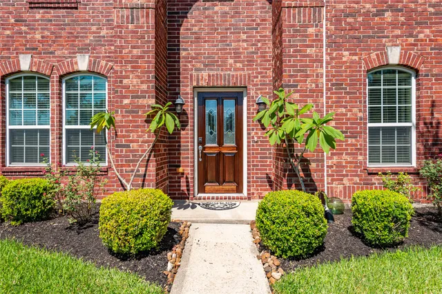 a front view of a house with lots of green space