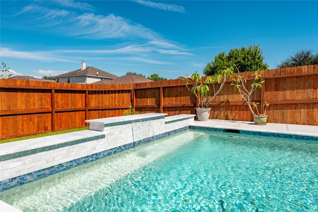 a view of a backyard with a garden and deck