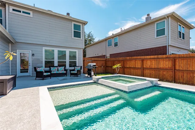 a view of an house with backyard space and sitting area