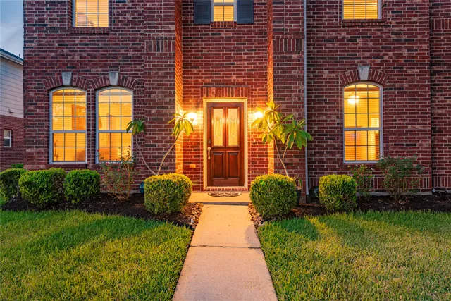 an aerial view of a house with a garden and lake view
