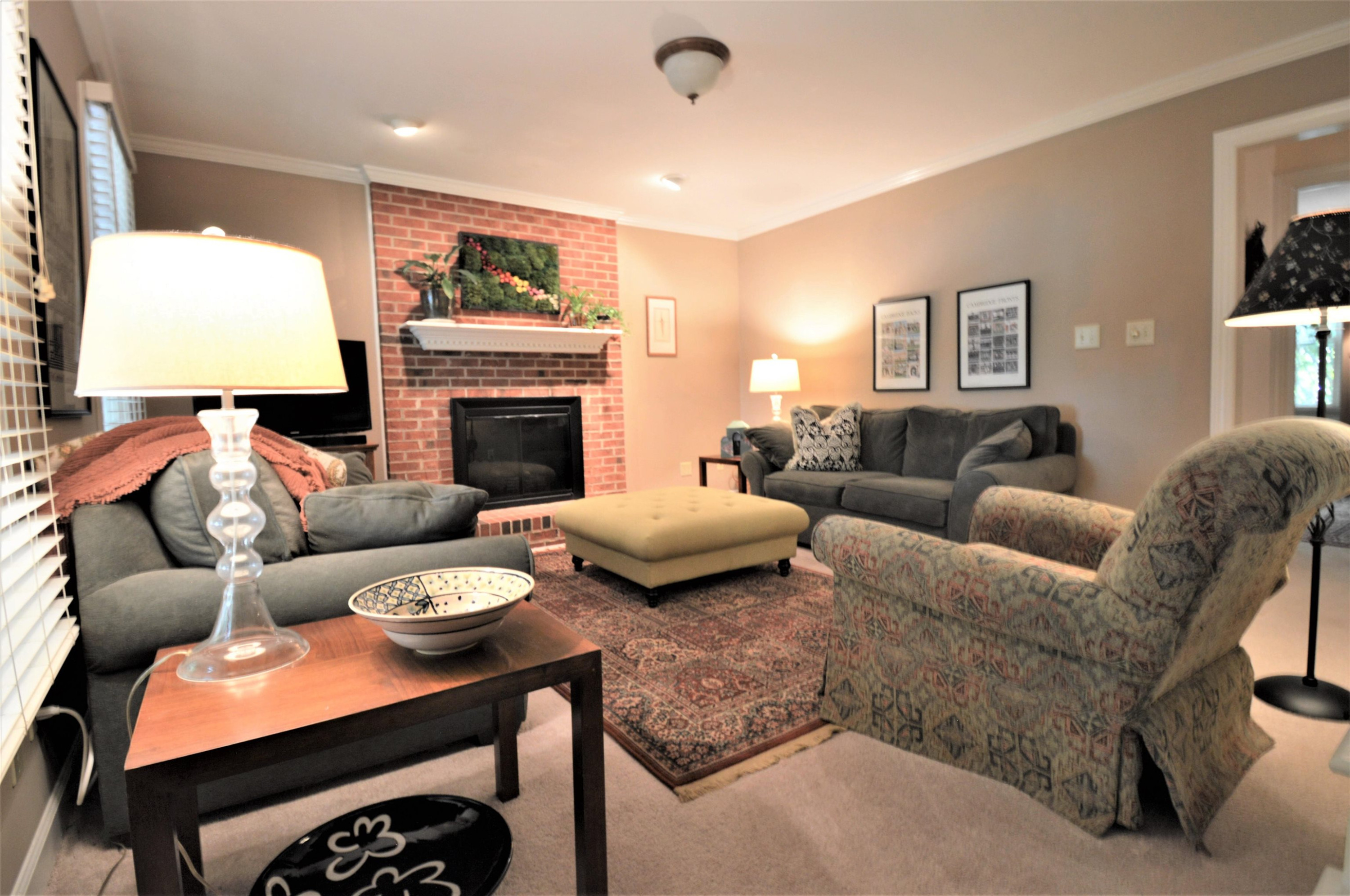 7008 Sandringham Drive Raleigh, NC 27613 - Photo 4 of 52 The living room has crown molding and a masonry fireplace with gas logs. Living Room