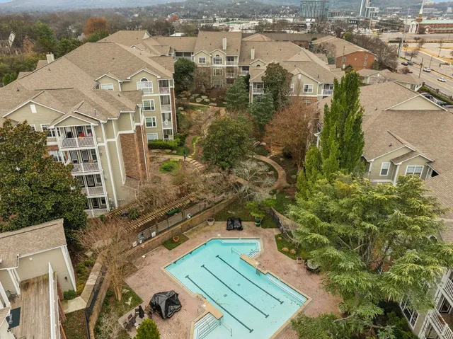 an aerial view of a residential apartment building with a yard