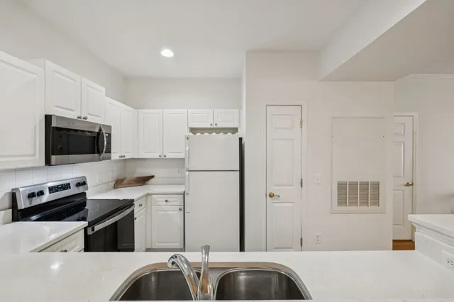 a kitchen with a sink a stove and refrigerator