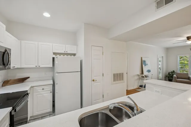 a kitchen with a refrigerator and a sink