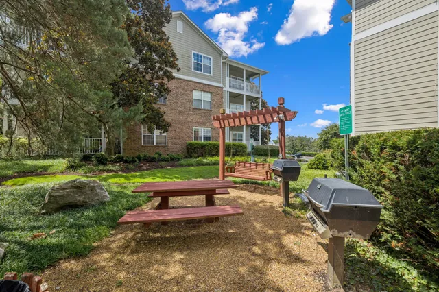 a view of a garden with a building in the background