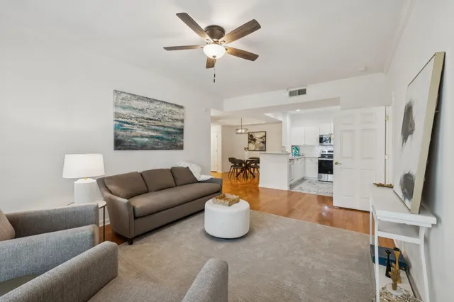 a living room with furniture a fireplace and a chandelier