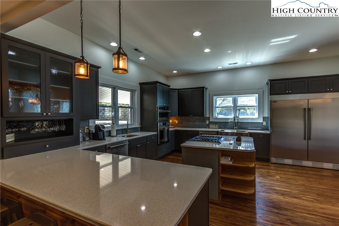 2388 Carsonville Road Independence, VA 24348 - Photo 11 of 50 a large kitchen with a table chairs and a wooden floor