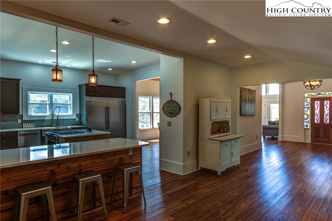 2388 Carsonville Road Independence, VA 24348 - Photo 22 of 50 a kitchen with stainless steel appliances kitchen island granite countertop a refrigerator a stove a sink and a oven with wooden floor