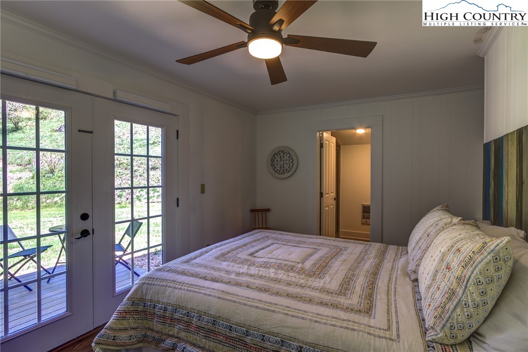 2388 Carsonville Road Independence, VA 24348 - Photo 30 of 50 a bedroom with a large bed and a chandelier