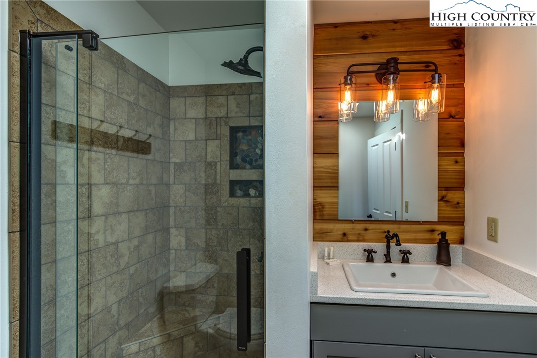 2388 Carsonville Road Independence, VA 24348 - Photo 34 of 50 a bathroom with a sink a mirror and shower