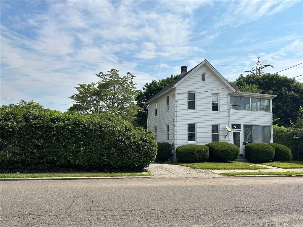 6 Scotland Street Ansonia, CT 06401 - Photo 1 of 1 a front view of a house with a yard and trees