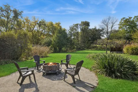 a view of a house with a yard and sitting area