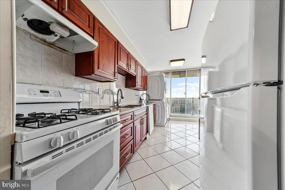 3900 West Ford Road, Unit 17P Philadelphia, PA 19131 - Photo 10 of 28 a kitchen with stainless steel appliances granite countertop a stove and a refrigerator