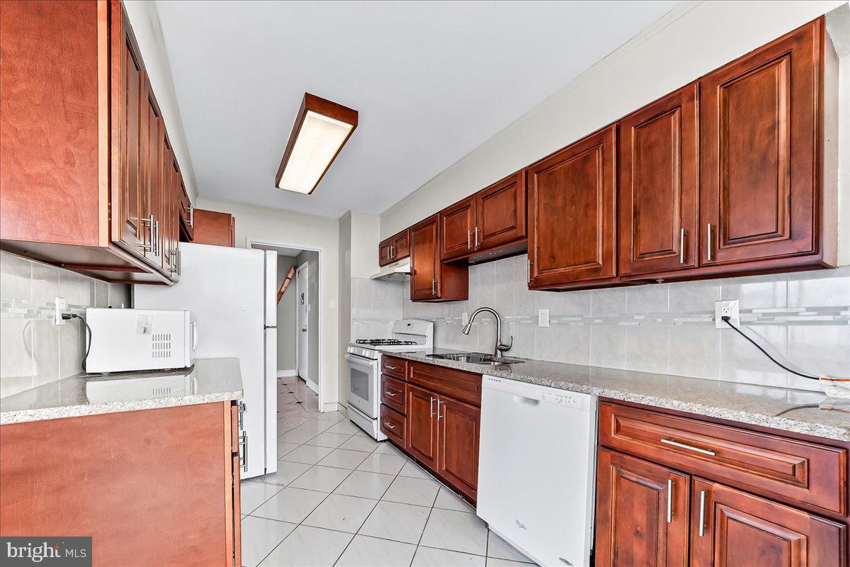 3900 West Ford Road, Unit 17P Philadelphia, PA 19131 - Photo 11 of 28 a kitchen with stainless steel appliances granite countertop a refrigerator and a sink