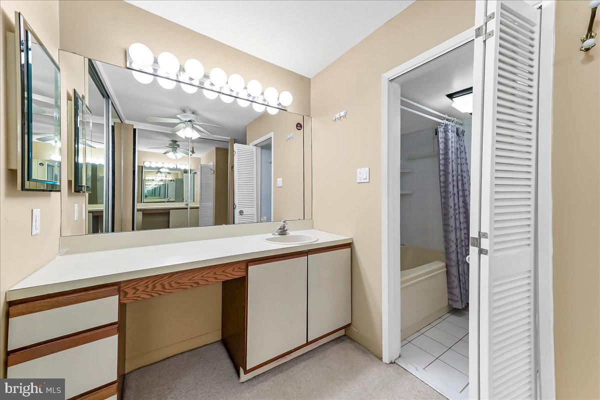 3900 West Ford Road, Unit 17P Philadelphia, PA 19131 - Photo 23 of 28 a bathroom with a double vanity sink and mirror