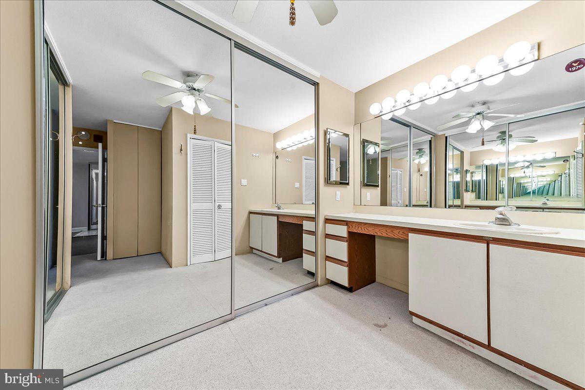 3900 West Ford Road, Unit 17P Philadelphia, PA 19131 - Photo 25 of 28 a large bathroom with a large mirror vanity and shower