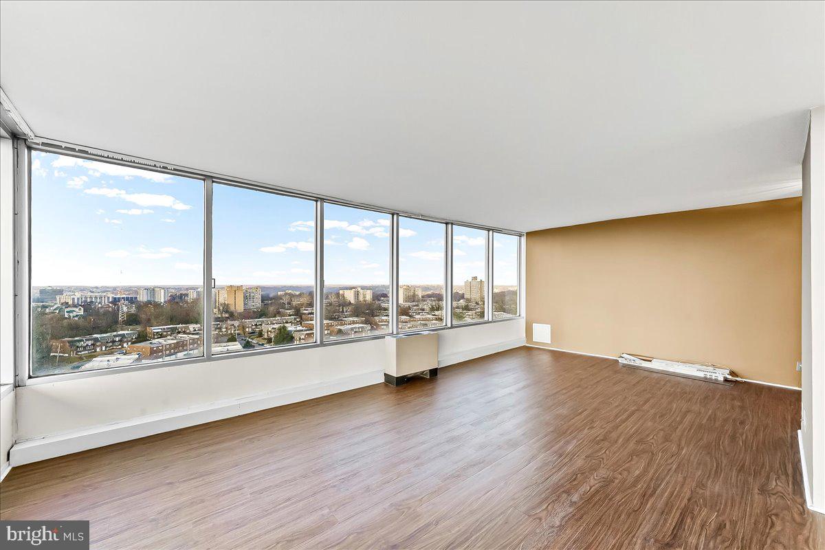 3900 West Ford Road, Unit 17P Philadelphia, PA 19131 - Photo 5 of 28 an empty room with wooden floor and windows