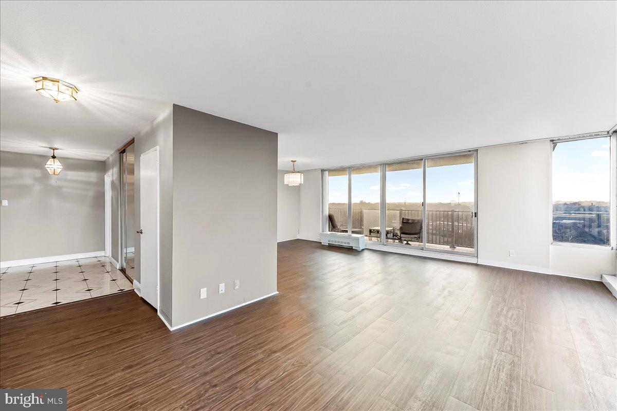 3900 West Ford Road, Unit 17P Philadelphia, PA 19131 - Photo 8 of 28 an empty room with wooden floor and windows