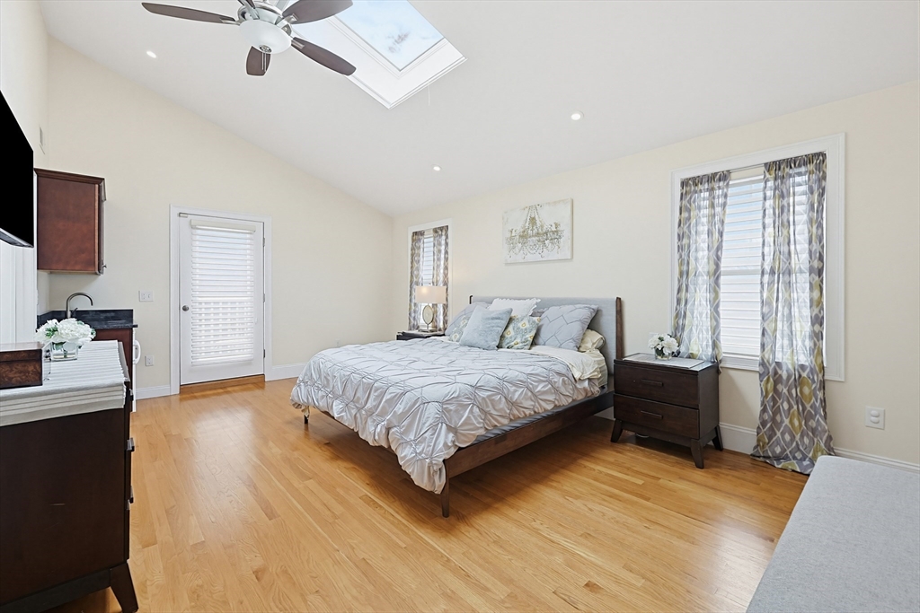 98-100 Lexington Street, Unit 100 Newton, MA 02466 - Photo 19 of 42 a spacious bedroom with a bed and dresser with wooden floor