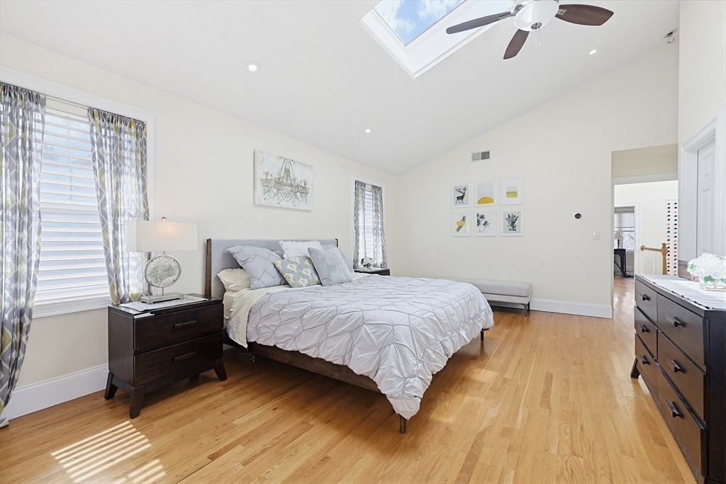 98-100 Lexington Street, Unit 100 Newton, MA 02466 - Photo 20 of 42 a bedroom with a bed and wooden floor