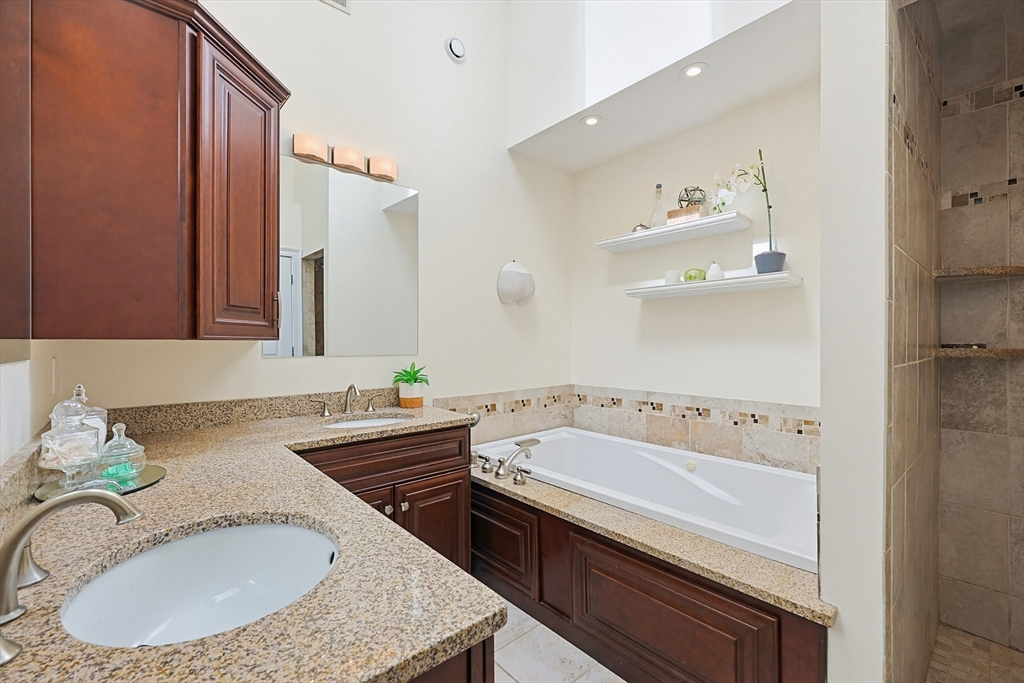 98-100 Lexington Street, Unit 100 Newton, MA 02466 - Photo 24 of 42 a bathroom with a tub sink and mirror