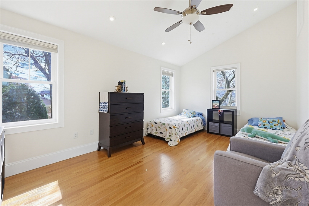 98-100 Lexington Street, Unit 100 Newton, MA 02466 - Photo 25 of 42 a bedroom with a bed and wooden floor