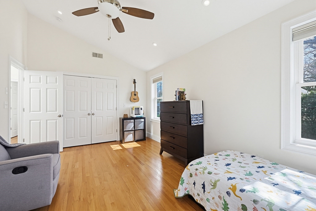 98-100 Lexington Street, Unit 100 Newton, MA 02466 - Photo 26 of 42 a bedroom with a bed and wooden floor