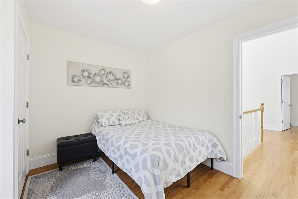 98-100 Lexington Street, Unit 100 Newton, MA 02466 - Photo 30 of 42 a bedroom with a bed and a table