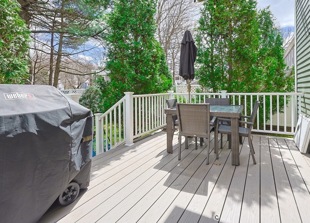 98-100 Lexington Street, Unit 100 Newton, MA 02466 - Photo 38 of 42 a view of a deck with furniture and trees