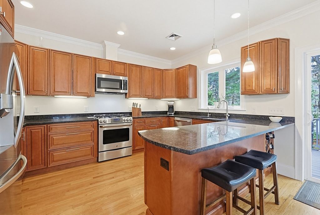 98-100 Lexington Street, Unit 100 Newton, MA 02466 - Photo 10 of 42 a kitchen with granite countertop a stove sink and cabinets